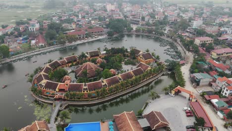 Aerial-drone-shot-of-buildings-surrounded-by-lakes-in-Vietnam-city