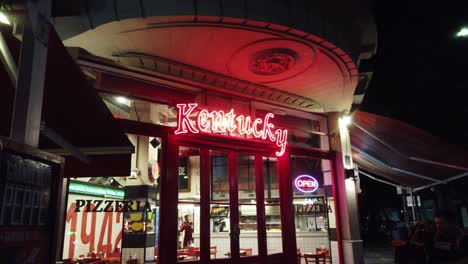 Kentucky-Pizzería-Entrada-Roja-Letrero-De-Neón-Vintage-En-Buenos-Aires-Noche-Gente-Argentina-Comida-Histórica-Entrada-De-La-Tienda