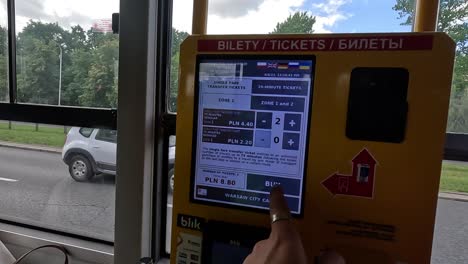 Utilizing-a-bus-ticket-vending-machine-to-purchase-tickets-exemplifies-the-process-of-obtaining-tickets,-a-common-practice-in-Warsaw,-Poland