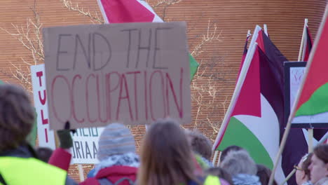 Defocused-placard-at-rally-calls-to-End-the-Occupation-in-Palestine