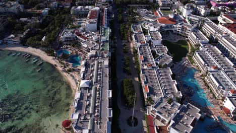 Aerial-View-of-Playa-Del-Carmen,-Mexico,-Luxury-Waterfront-Hotels-and-Buildings-on-Caribbean-Sea,-Revealing-Drone-Shot