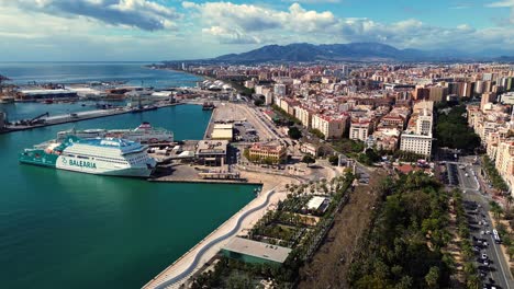 Balearia-Cruise-ship-docked-moored-at-Malaga-city-port-Spain-aerial-city