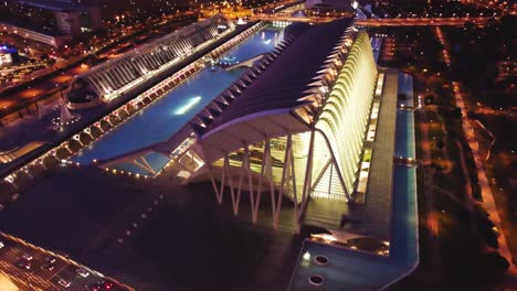 Assut-de-l'Or-Bridge---Evening-Sunset-and-City-Lights,-Over-Valencia-Spain's-'City-of-Arts-and-Sciences':-A-Cinematic-View,-traffic-driving-across-bridge-at-golden-hour