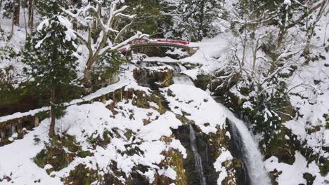 Waterfall-at-Ginzan-Onsen-Silver-Mine,-Snowy-Winter-Landscape