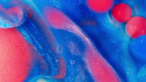 Glittering-red-and-blue-liquid-ink-fluid-mixed-together,-abstract-art