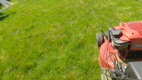 side-of-lawn-mower,-mowing-grass