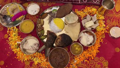 Closeup-view-of-Bengali-traditional-food-with-fish,-rice-and-sweet-platter
