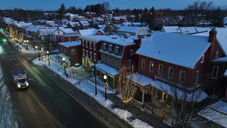 American-town-with-snow-and-Christmas-lights-during-snowy-winter-morning