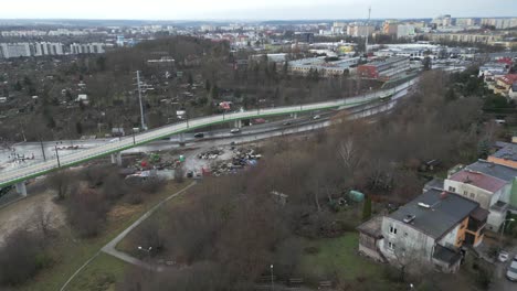 Drone-view-of-the-city-skyline-with-a-viaduct-and-roads-with-cars-driving-on-them