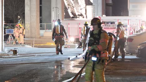 Firefighters-working-at-abandoned-fire-incident-site,-Montréal,-Québec,-Canada