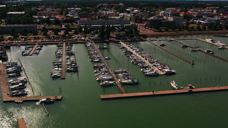 Aerial-tracking-shot-in-front-of-the-marina-of-Mariehamn,-summer-in-Aland,-Finland