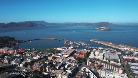 Drone-Shot-of-San-Francisco-USA-Piers,-Museum-Ships,-Fisherman's-Wharf-and-Alcatraz-Island-in-Bay