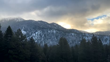 Timelapse-Of-Clouds-Rolling-Over-Snow-Capped-Mountains-Of-Lake-Tahoe,-Nevada