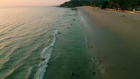 4K-Cinematic-nature-drone-footage-of-a-panoramic-aerial-view-of-the-beautiful-beaches-and-mountains-on-the-island-of-Koh-Lanta-in-Krabi,-South-Thailand,-during-sunset