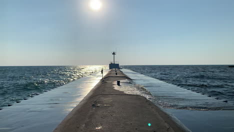 Water-splashes-on-a-pier-as-the-sun-is-shining-in-the-afternoon