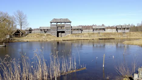 panoramic-view-of-cineville-Latvia-with-nature-pond-lake-and-wooden-building-at-distance
