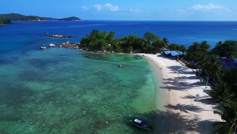 Tropical-island-bay-palm-beach,-turquoise-clear-water