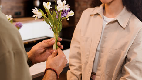 Man-giving-flower-to-woman