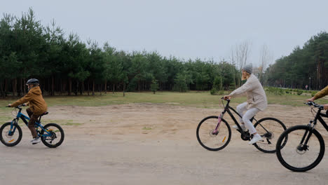 Familia-Andando-En-Bicicleta-Al-Aire-Libre