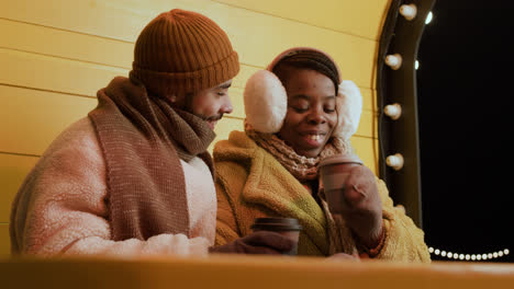 Black-couple-drinking-outside