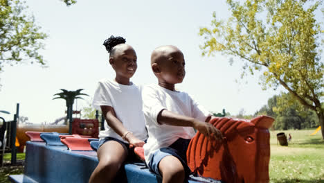 Happy-kids-waving-on-a-rocking-horse