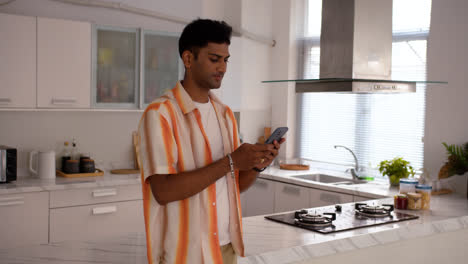 Happy-indian-guy-using-smartphone