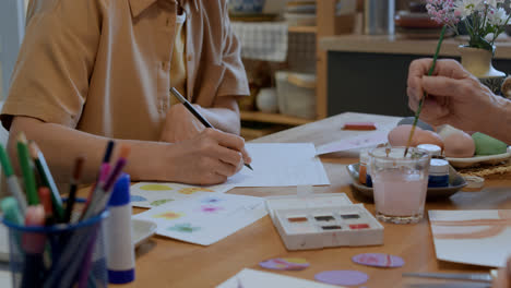 Woman-writing-and-erasing-text-for-Easter-Card