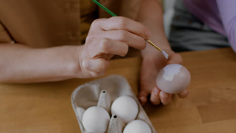 Person-painting-Easter-ornaments