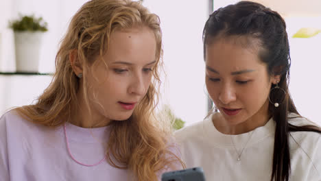 Two-girls-using-smartphone