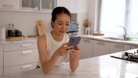 Happy-asian-girl-using-smartphone