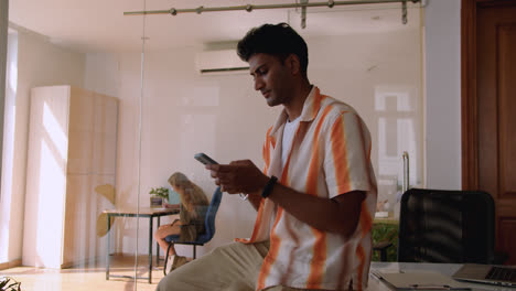 Happy-indian-guy-using-smartphone