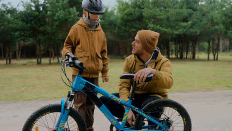 Dad-checking-his-son's-bike