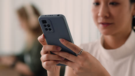 Woman-using-smartphone-at-the-office