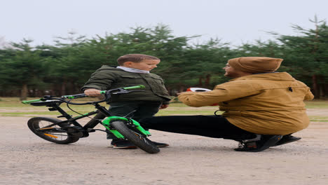 Dad-putting-bike-helmet-on-son