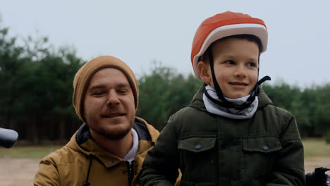 Dad-and-son-smiling-at-camera