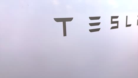 Tesla-Powerwall-up-close-scrolling-across-logo-on-battery-storage-unit