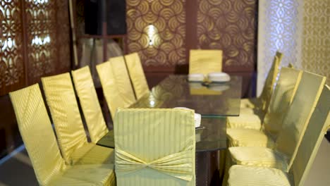 This-gorgeous-close-up-shot-capturing-a-long-dining-table-at-a-classic-Asian-wedding-with-stunning-golden-chairs