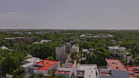 Tulum-Mexico-Aerial-v24-low-drone-flyover-the-outer-town-luxury-neighborhood-capturing-newly-built-properties-surrounded-by-lush-and-dense-greenery---Shot-with-Mavic-3-Pro-Cine---July-2023