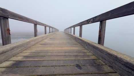 Strolling-along-the-waterfront-promenade,-made-of-wood,-ignites-the-thrill-of-exploration-and-adventure-amid-aquatic-surroundings