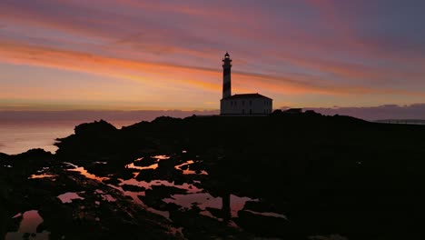 Aerial-Shot-of-Favaritx-Lighthouse-Menorca-Historic-Landmark-Sunset-Skyline-at-natural-coastal-environment
