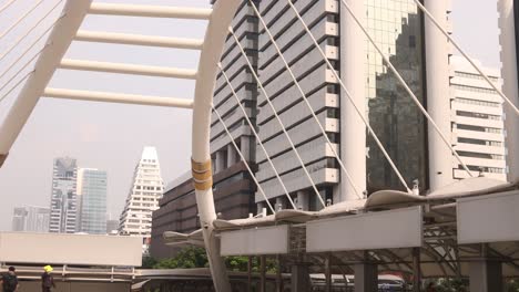 pedestrian-cable-bridge-through-downtown-business-district-of-Bangkok,-the-capital-city-of-Thailand