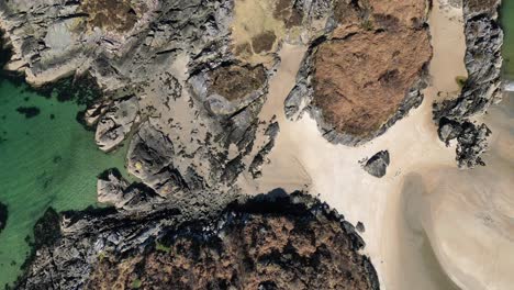 sandy-beach,-rocks-and-blue-green-sea---Camas-an-Lighe---Scotland---aerial