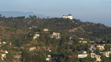 Griffith-Observatory-landscape-over-private-homes-in-the-hills-at-sunset