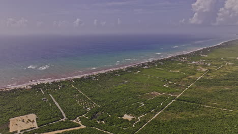 Tulum-Mexico-Aerial-v26-high-altitude-drone-flyover-towards-beachfront-resort-town-capturing-long-stretch-of-sandy-beach-and-pristine-Caribbean-sea-views---Shot-with-Mavic-3-Pro-Cine---July-2023