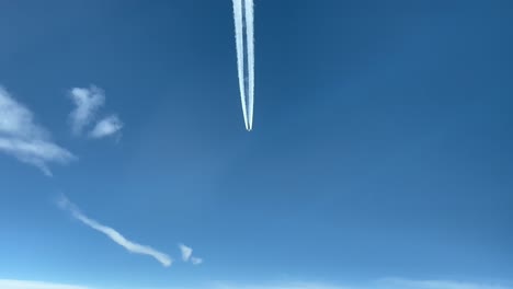 Exclusive-far-aerial-shot-from-a-jet-cockpit-chasing-a-previous-higher-jet-with-a-white-wake