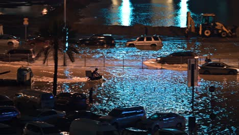 On-April-16,-2024,-traffic-navigated-through-a-flooded-road-at-night-in-Sharjah,-UAE,-after-record-breaking-rains-hit-the-country