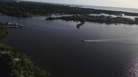 Aerial-view-boat-making-its-way-across-Millers-Bayon,-Port-Richey,-Florida