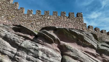 Aerial-drone-view-of-the-walls-and-tower-of-a-stoney-castle-in-the-top-of-a-rocky-hill-in-Guadalajara,-Spain