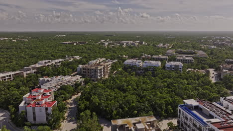 Tulum-Mexico-Aerial-v13-drone-flyover-luxury-residential-neighborhood-capturing-new-property-developments,-landscape-of-lush-forests,-blue-sky-and-ocean-views---Shot-with-Mavic-3-Pro-Cine---July-2023