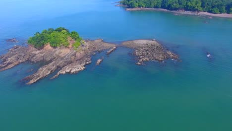 Drone-flying-down-over-a-little-rocky-island-in-Boca-Chica-off-the-coast-of-Panama-in-Central-America